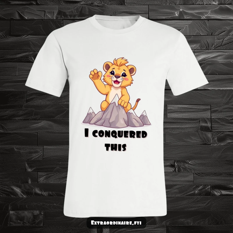 Funny lion cub climber t-shirt, showing a cub raising paws victoriously atop miniature mountains.
