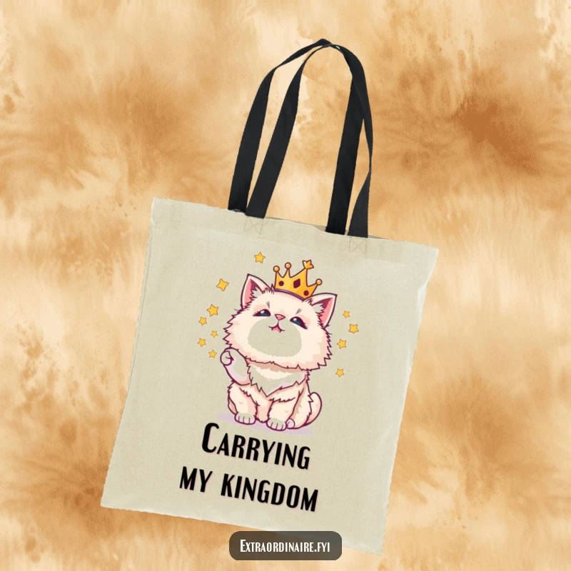 Funny tote bag featuring a crowned cat juggling stars, a whimsical and practical accessory.